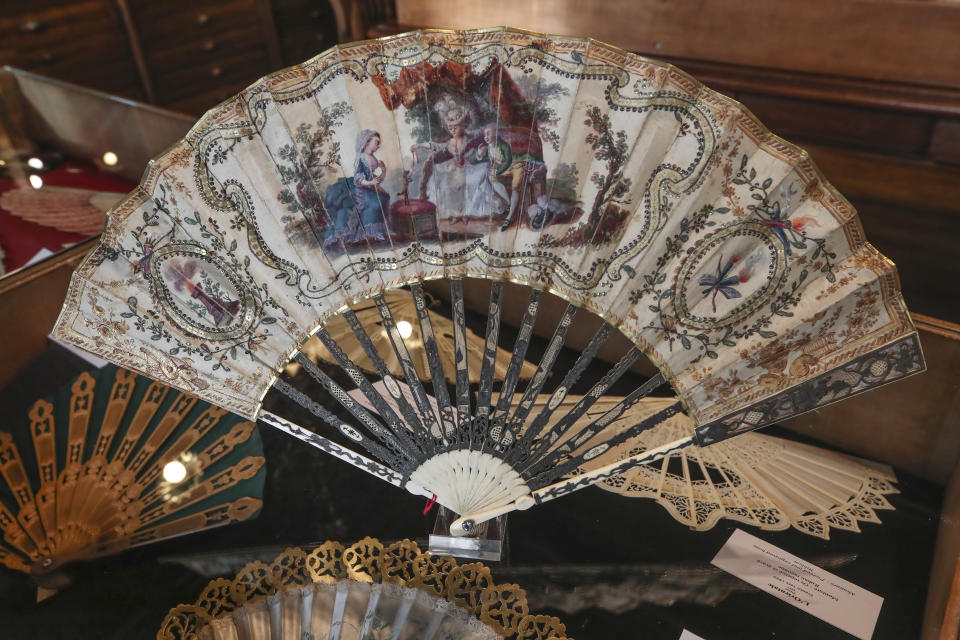 A hand fan representing a learned dog (Chien savant), gouache painting on silk dated from 1775, is displayed at the hand fan-making museum in Paris, Wednesday, Jan. 20, 2021. Just like the leaves of its gilded fans, France's storied hand fan-making museum could fold up and vanish. The splendid Musee de l'Eventail in Paris, a classed historical monument, is the culture world's latest coronavirus victim. (AP Photo/Michel Euler)