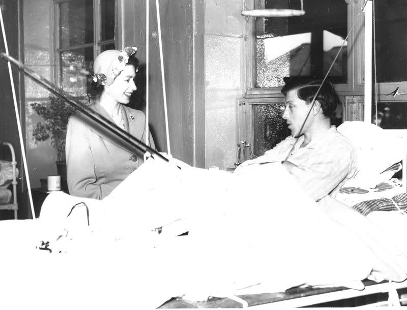 Handout photo of Britain's Princess Elizabeth visiting a Red Cross hut for tuberculosis patients