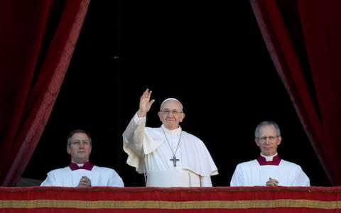 Pope Francis waves after delivering the "Urbi et Orbi" message from the main balcony of Saint Peter's Basilica  - Credit: REUTERS/Max Rossi