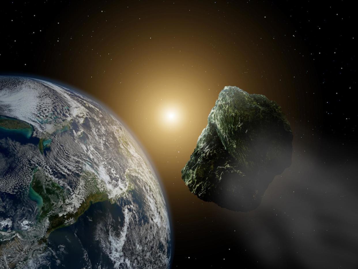 Asteroid in space near earth in sunlight: Getty Images