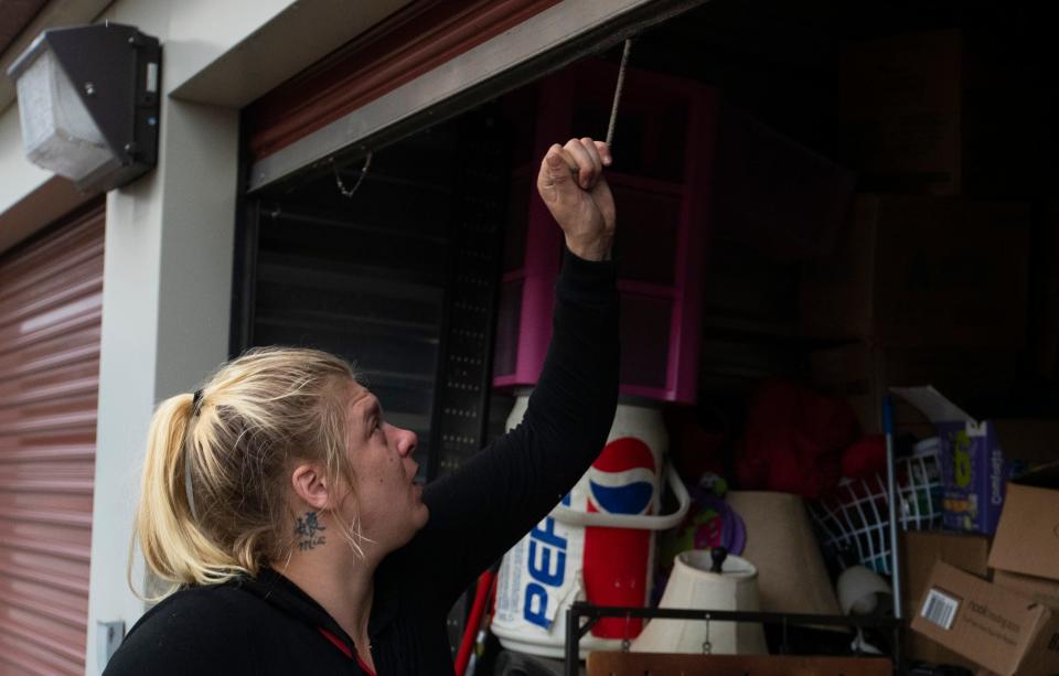 Morgan Rose goes through the storage unit, Thursday, June 29, 2023, in Lafayette, Ind. 