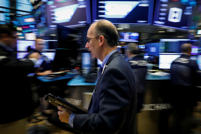 Traders work on the floor of the New York Stock Exchange (NYSE) in New York, U.S., October 22, 2018. REUTERS/Brendan McDermid