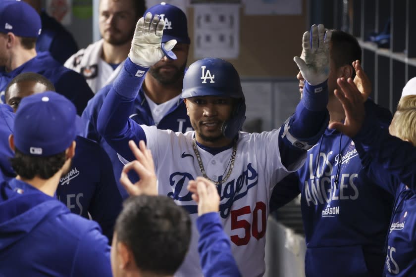 Los Angeles, CA - October 12: Los Angeles Dodgers' Mookie Betts celebrates with the dugout after a sacrifice fly that scored Cody Bellinger during the fifth inning in game four of the 2021 National League Division Series against the San Francisco Giants at Dodger Stadium on Tuesday, Oct. 12, 2021 in Los Angeles, CA. (Robert Gauthier / Los Angeles Times)
