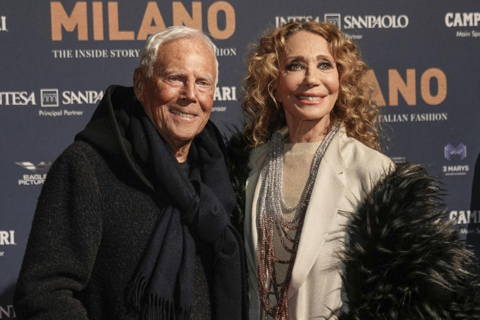 Designer, left, Giorgio Armani and Marisa Berenson pose for photographers upon arrival for the premiere of the film 'Milano, the inside story of Milan Fashion' in Milan, Italy, Sunday, Feb. 26, 2023. (AP Photo/Luca Bruno)