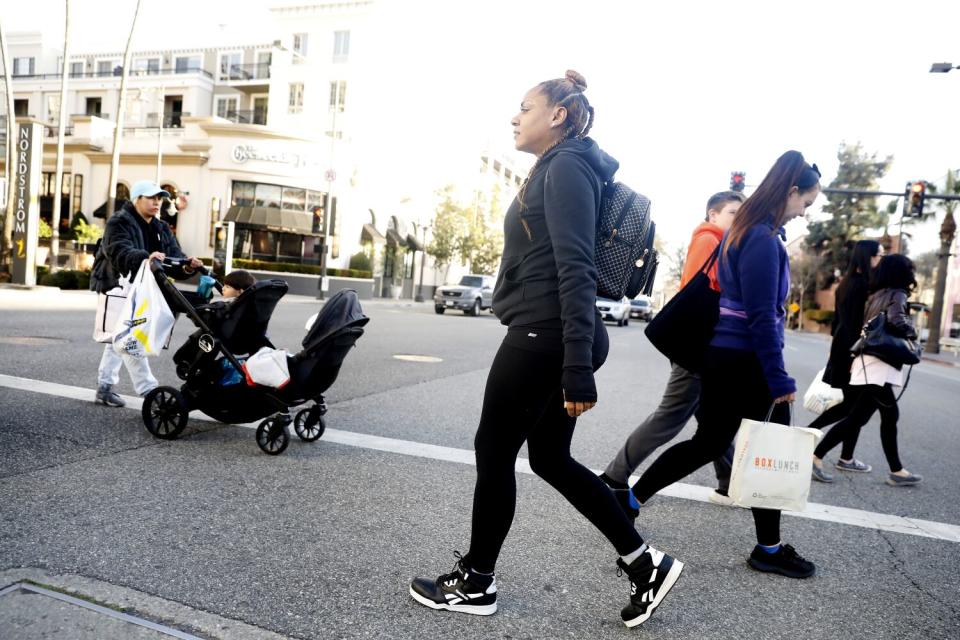 Graham walks from the bus stop to her job at a retail store in Glendale.