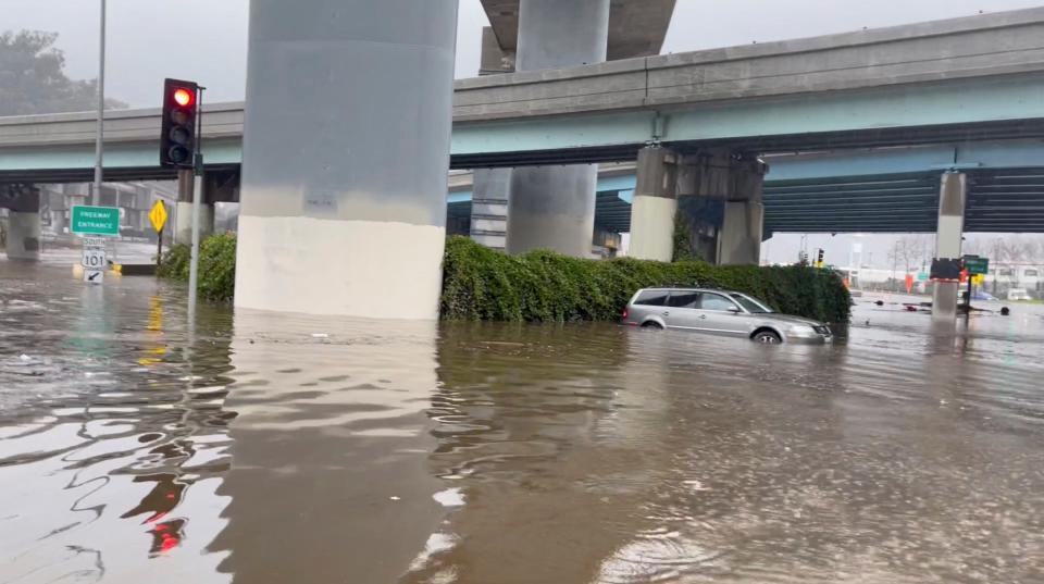 flooding under highway partially submerges a car in san francisco