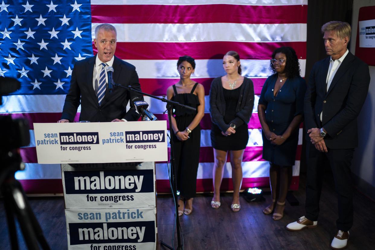 New York 17th Congressional District Democratic primary candidate U.S. Rep. Sean Patrick Maloney, left, delivers his victory speech next to his daughters and his husband, Randy Florke, right, during an election night party in Peekskill, N.Y., Tuesday, Aug. 23, 2022. 