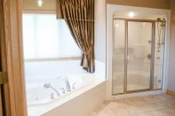 <p><span>15 Briarwood Way, Stony Plain, Alta.</span><br> The master ensuite, one of four-and-a-half bathrooms in the home, has an air-jet tub.<br> (Photo: Zoocasa) </p>