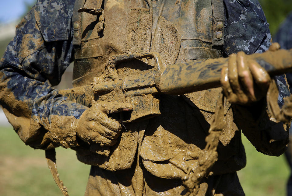 Midshipman carries a dummy rifle