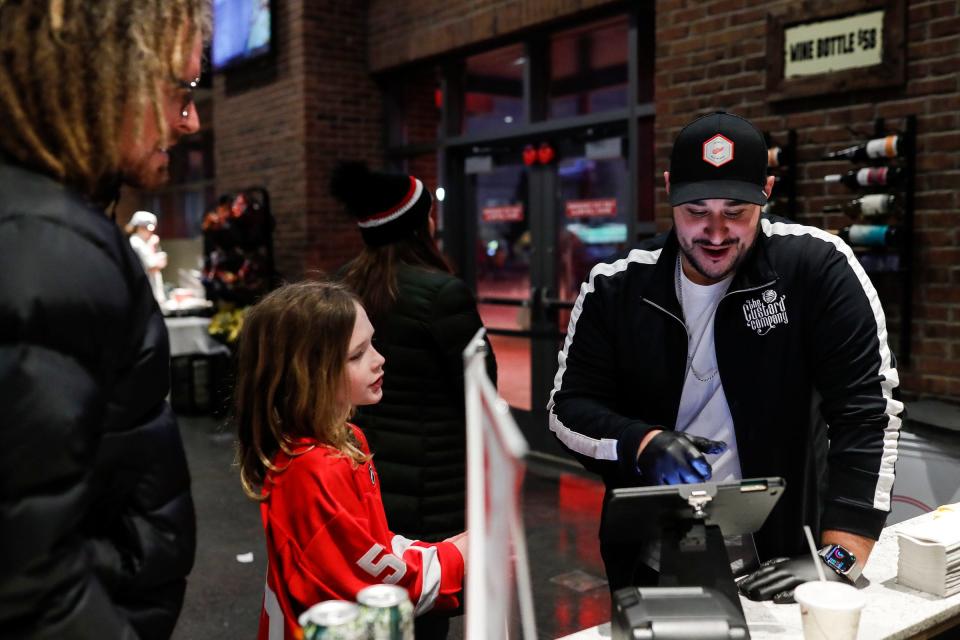 Jamal Jawad takes order from Red Wings fans at the Custard Co. stand before a Red Wings game against Blackhawks at Little Caesars Arena in Detroit on Wednesday, March 8, 2023.