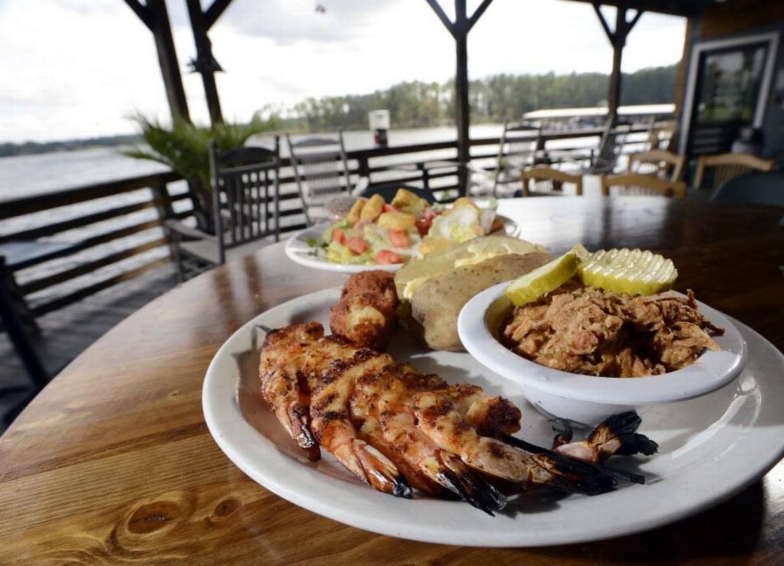 Grilled shrimp and barbecue pork with baked potato and salad at Fish ‘n’ Pig.