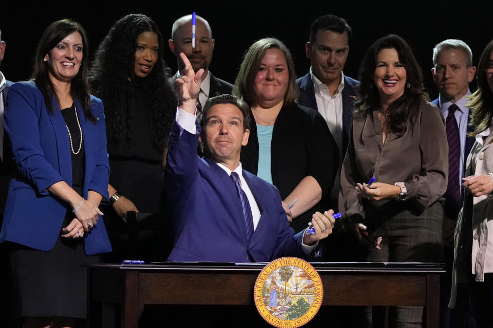 FILE - Florida Gov. Ron DeSantis throws markers into the audience after signing various bills during a bill signing ceremony at the Coastal Community Church at Lighthouse Point on May 16, 2023, in Lighthouse Point, Fla. (AP Photo/Wilfredo Lee, File)