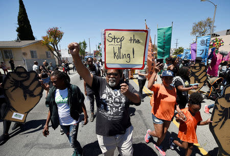 Protesters march from the intersection of Florence and Normandie Avenue, the flashpoint where the riots started 25 years ago, to a nearby park for a rally to remember and honor the victims of the 1992 Los Angeles riots in Los Angeles, California, U.S., April 29, 2017. REUTERS/Kevork Djansezian