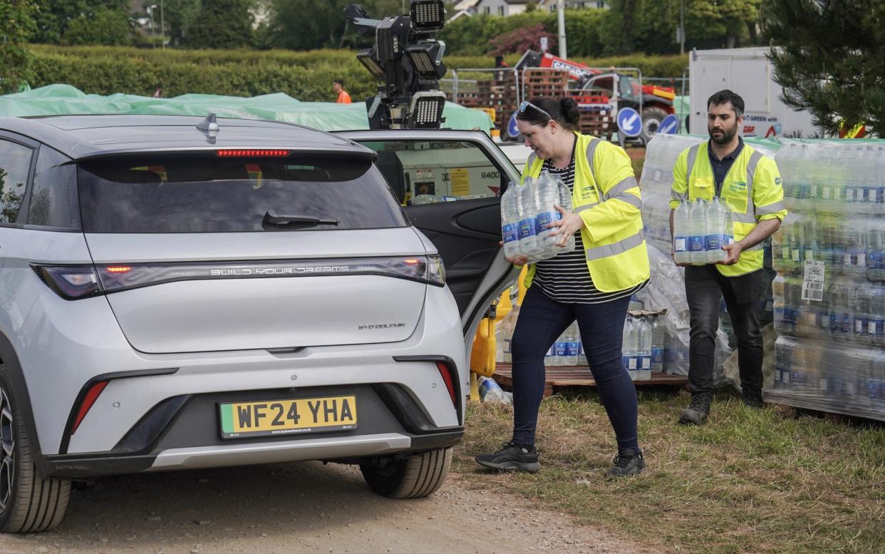 Volunteers distribute bottled water in Brixham