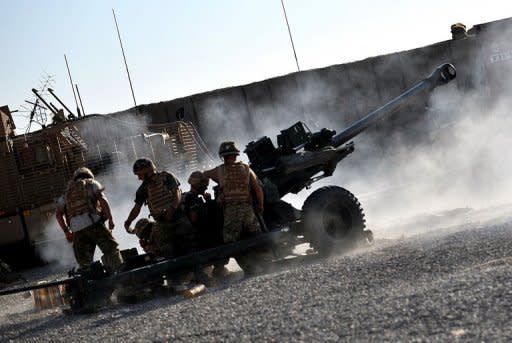 Soldiers of 88 Battery 4 Regiment Royal Artillery fire a 105 mm light gun towards an insurgent position from their base in Nahr e Saraj, Helmand on Saturday. Defence Minister Philip Hammond says the "cowardly" killing of three British soldiers in Afghanistan by a man in police uniform will not derail the mission to build up Afghanistan's security forces