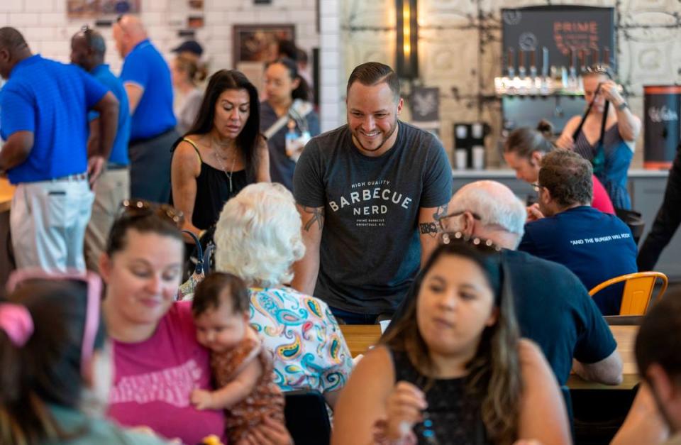 Chris Prieto, owner of Prime Barbecue, mingles with customers in a crowded dinning room during the lunch hour on Friday, August 18, 2023 in Knightdale, N.C.