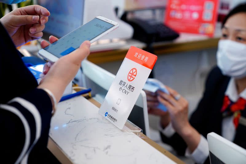 FILE PHOTO: A sign indicating digital yuan, also referred to as e-CNY, is pictured at a shopping mall in Shanghai