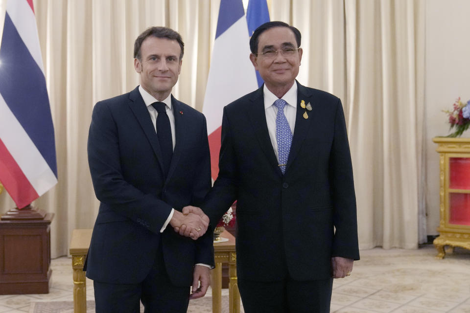 French President Emmanuel Macron, left, shakes hands with Thailand's Prime Minister Prayuth Chan-ocha at the Government House, Thursday, Nov. 17, 2022, in Bangkok, Thailand. (AP Photo/Sakchai Lalit, Pool)