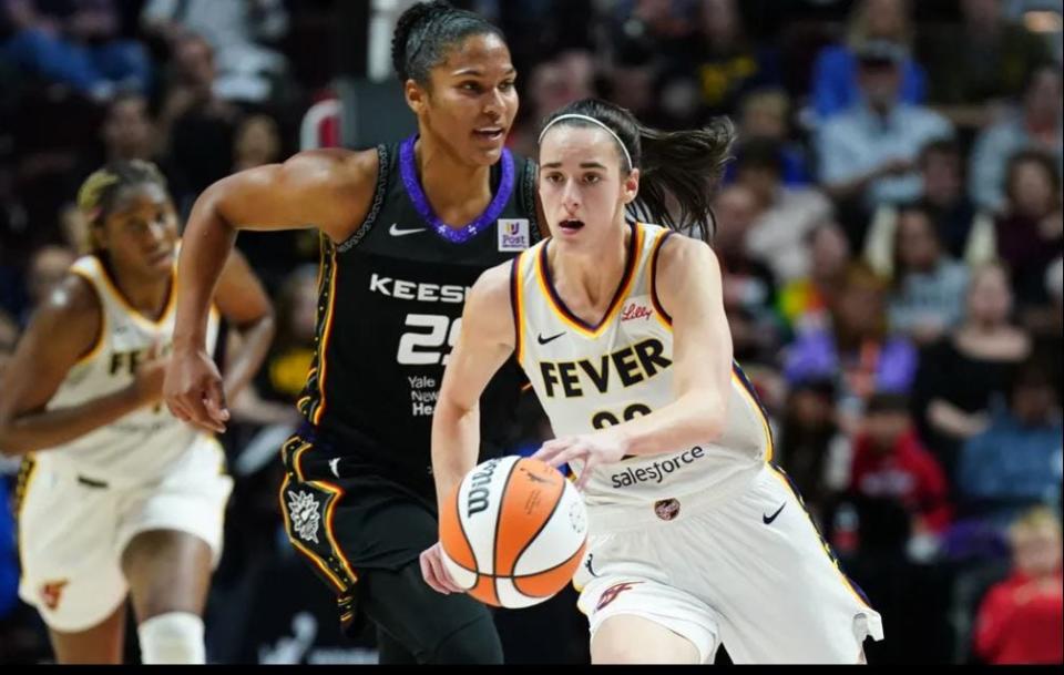 Indiana Fever guard Caitlin Clark (22) returns the ball against the Connecticut Sun in the second quarter at Mohegan Sun Arena in Uncasville, Connecticut, on May 14, 2024.
