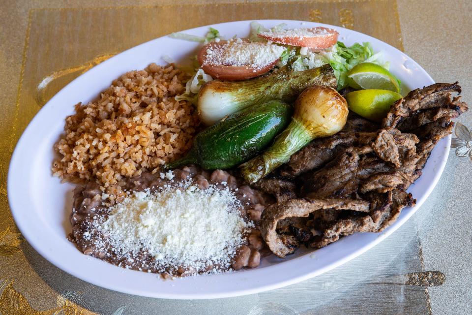 A "carnitas" platter, with rice, beans, jalepeno, onions, cheese, lemon and salad, is featured at Tortilleria Dos Milpas in Elsmere, Tuesday, Oct. 24, 2023. Dos Milpas makes tortillas from nixtamalized corn, with Michoacan-style carnitas, and is part of the reason why northern Delaware is deemed to have some of the best Mexican food in the region.