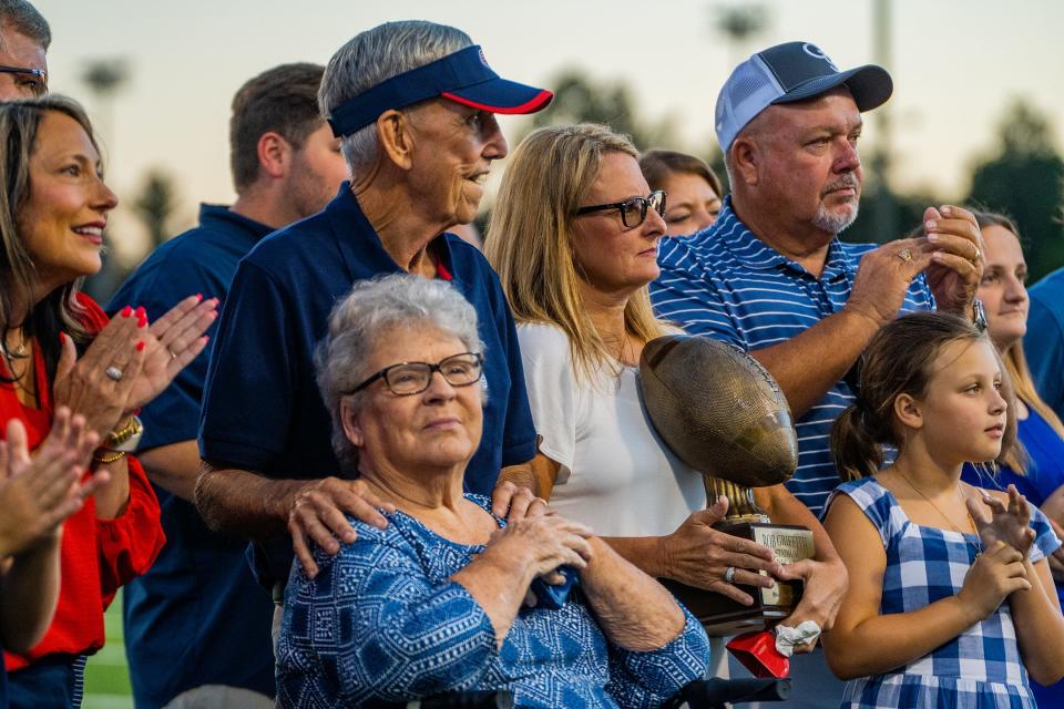 Coach Bob Griffith is surrounded by his family while being honored ahead of the game.