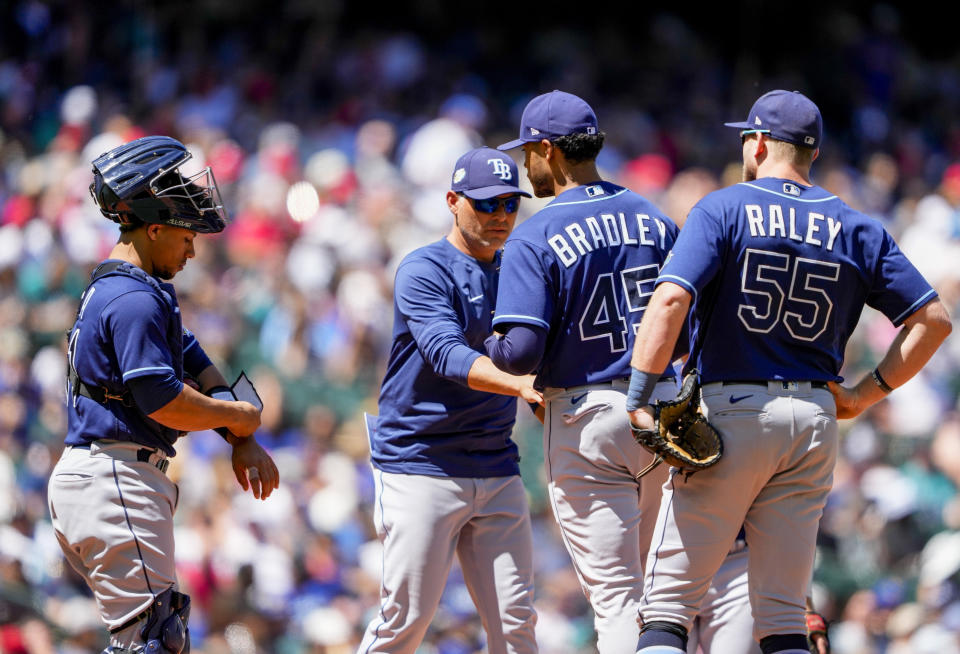 Tampa Bay Rays starting pitcher Taj Bradley is taken out of a baseball game against the Seattle Mariners by manager Kevin Cash during the fourth inning as first baseman Luke Raley (55) and catcher Francisco Mejia, left, look on, Sunday, July 2, 2023, in Seattle. (AP Photo/Lindsey Wasson)
