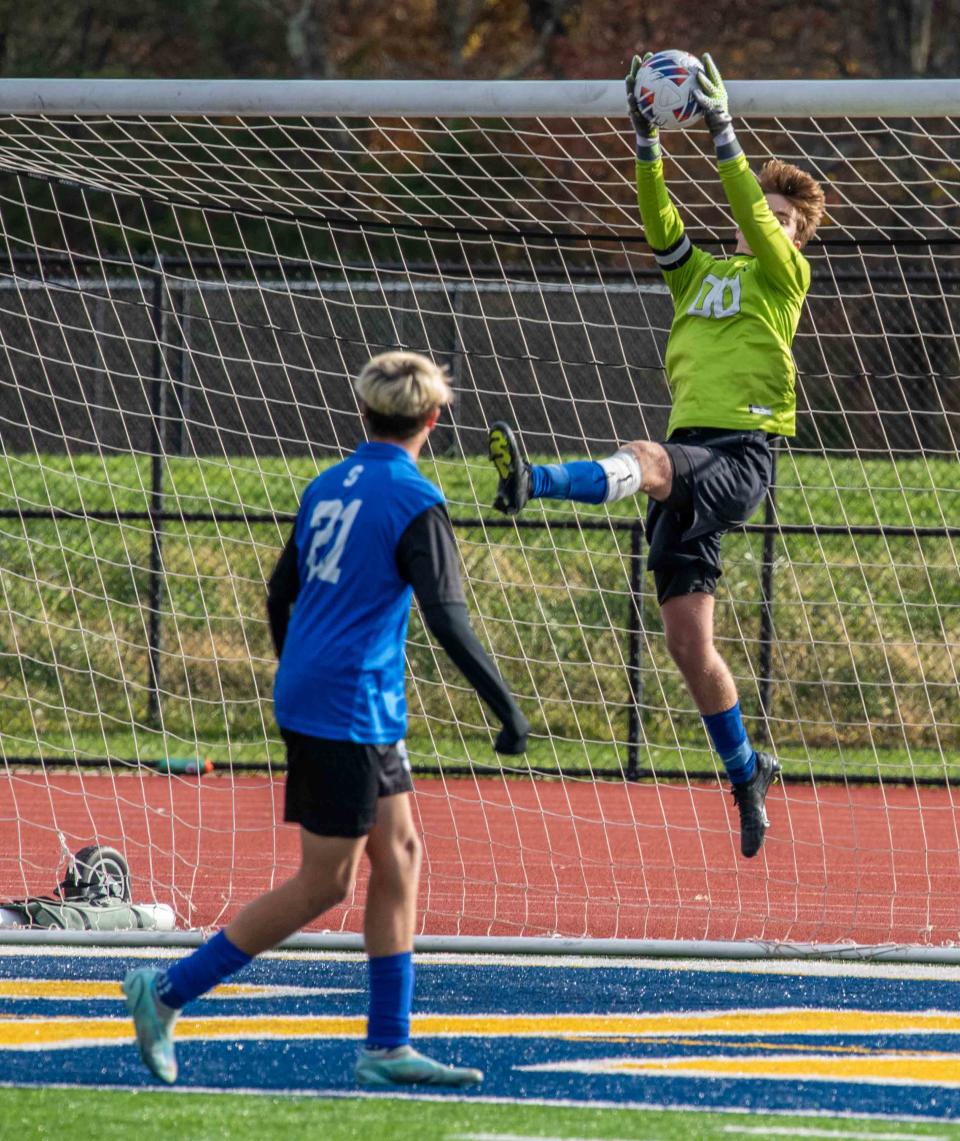 Shore's Kevin Barfield grabs a shot from a free kick