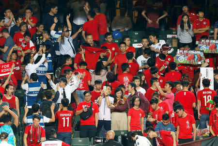 Security guards wave to urge Hong Kong fans stop booing and turning their backs during Chinese national anthem, at the Asian Cup preliminary match between Hong Kong and Lebanon in Hong Kong, China November 14, 2017. REUTERS/Bobby Yip