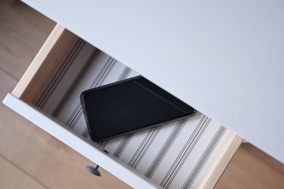 mobile phone in open drawer