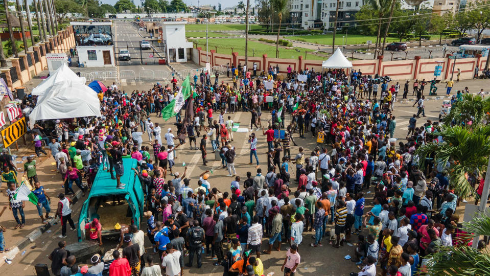 Image: Protesters gather at the front of Alausa, the Lagos State Secretariat, while chanting a people united can never be defeated in Lagos (Benson Ibeabuchi / AFP - Getty Images)