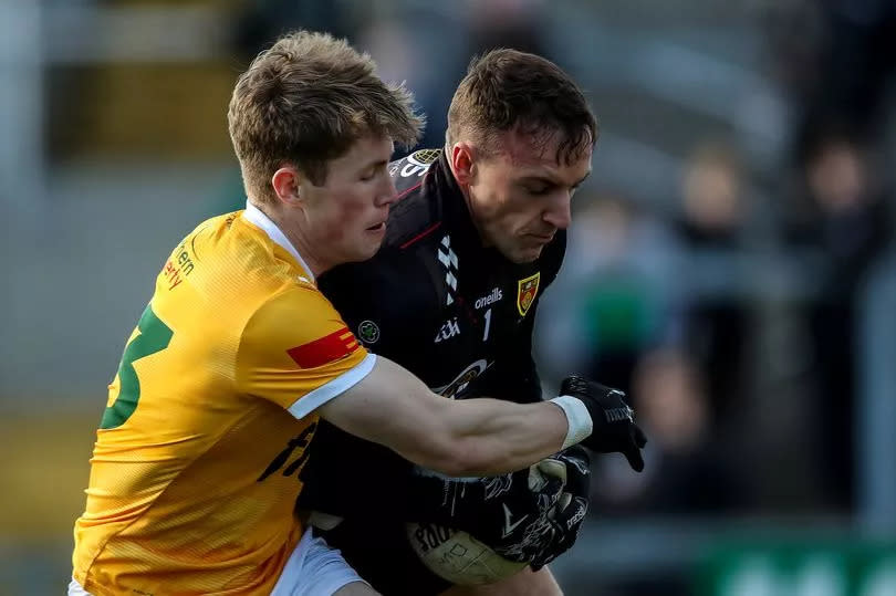 Antrim's Ryan McQuillan tackles Down goalkeeper John O'Hare