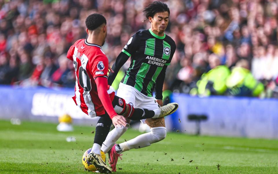 Sheffield United's Mason Holgate fouls Brighton & Hove Albion's Kaoru Mitoma before being shown a red card