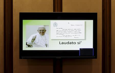 A monitor displays Pope Francis' new encyclical titled "Laudato Si (Be Praised), On the Care of Our Common Home", during the presentation news conference at the Vatican June 18, 2015. REUTERS/Max Rossi