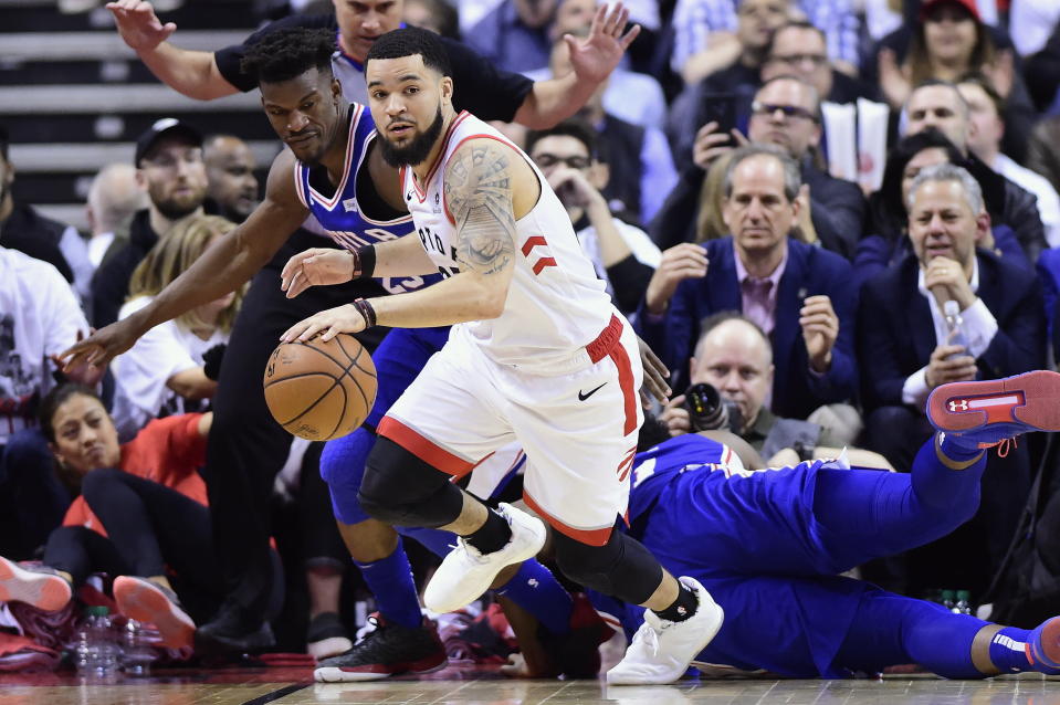 Toronto Raptors guard Fred VanVleet (23) recovers the ball ahead of Philadelphia 76ers guard Jimmy Butler (23) during second-half, second-round NBA basketball playoff action in Toronto, Monday, April 29, 2019. (Frank Gunn/The Canadian Press via AP)