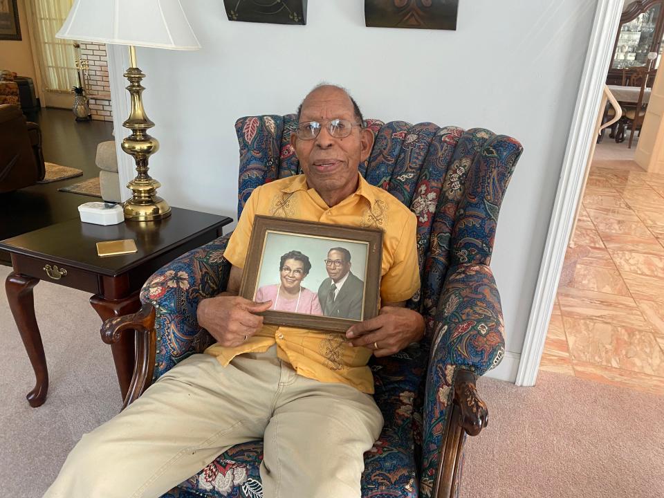 Dee Foster holds a photo of his parents, Robert and Louise Foster, in brother Donald Foster's home in Chillicothe on July 11, 2023.