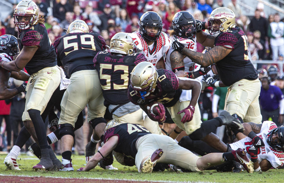 After taking a direct snap, Florida State running back Jashaun Corbin (0) dives for the end zone and scores a touchdown during the second half of the team's NCAA college football game against North Carolina State in Tallahassee, Fla., Saturday, Nov. 6, 2021. N.C. State won 28-14. (AP Photo/Mark Wallheiser)