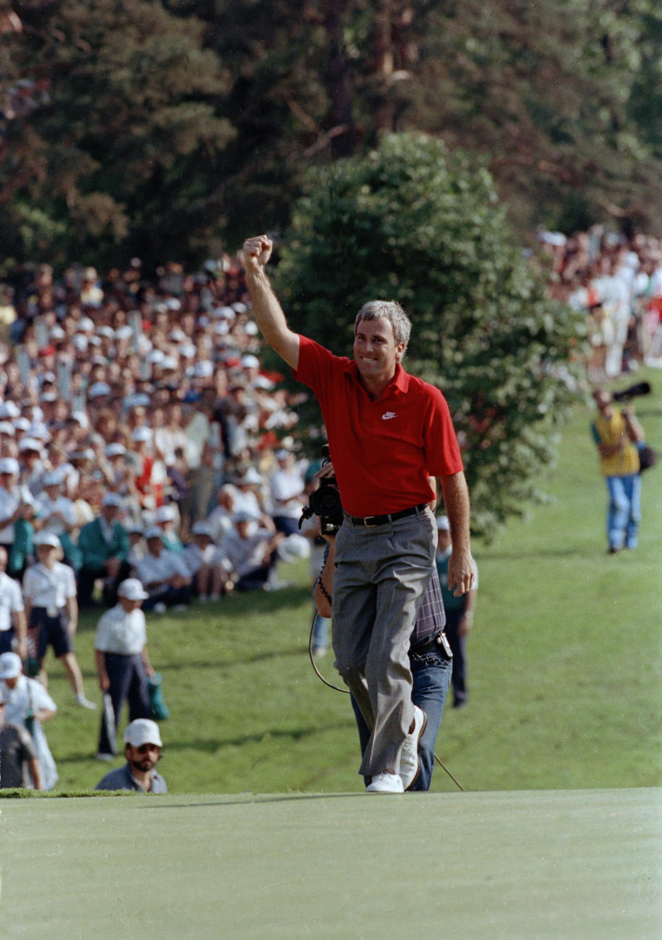 FILE- Curtis Strange reaches the 18th green waving to the crowd as he is about to win the U.S. Open for the second straight year, June 18, 1989, at the Oak Hill Country Club in Rochester, N.Y. Strange returns to Oak Hill for the PGA Championship on May 18-21 as part of the ESPN broadcast team. (AP Photo/Tom Kilips)