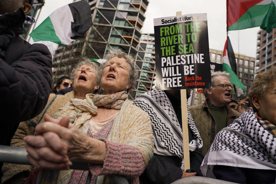 Demonstrators hold flags and placards as they attend a march in support of the Palestinian people in Gaza, in London, Saturday, March 9, 2024.(AP Photo/Alberto Pezzali)