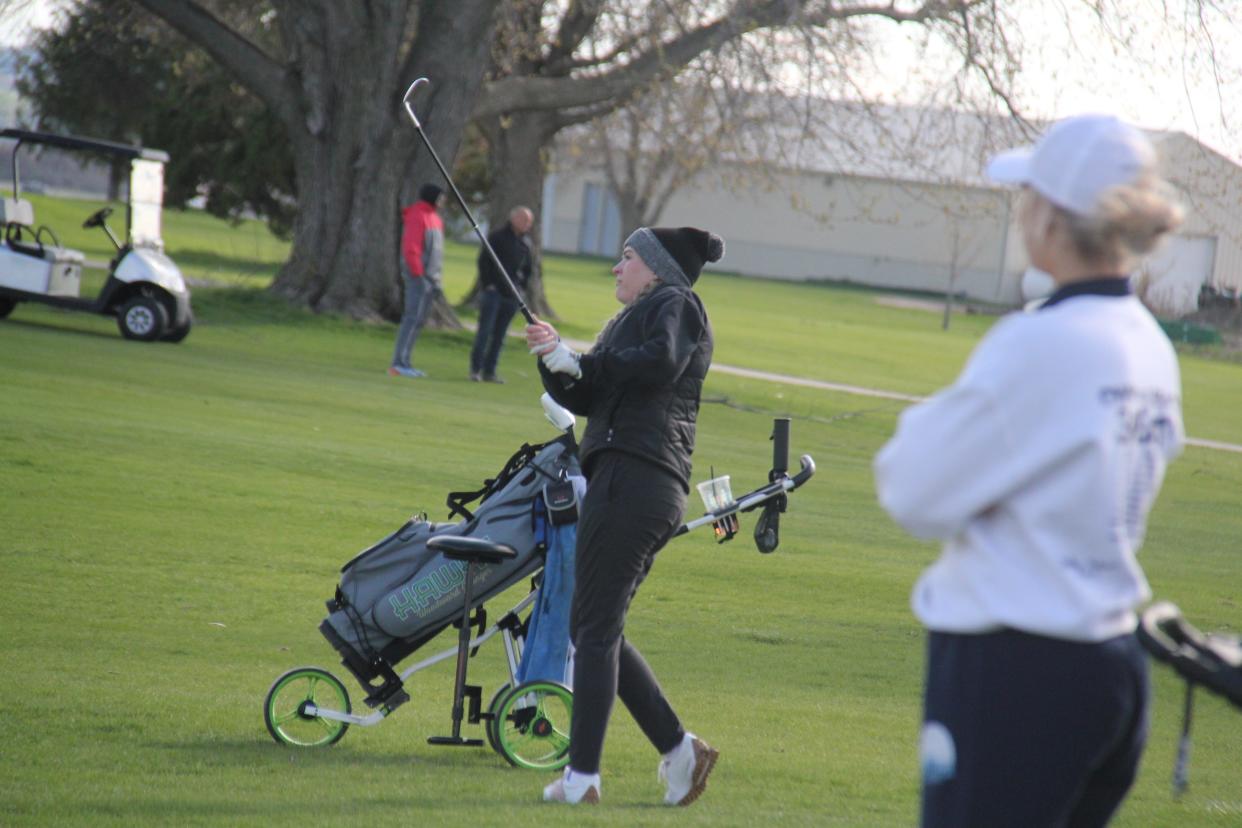 Woodward-Granger's Molly Cue watches her shot during a meet on Thursday, April 18, 2024, at Woodward Golf Club.