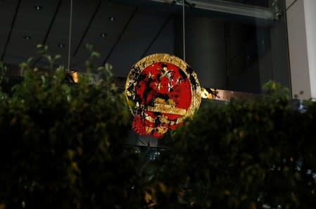 A National Emblem of the People's Republic of China is seen vandalised on Chinese Liaison Office after a march to call for democratic reforms, in Hong Kong