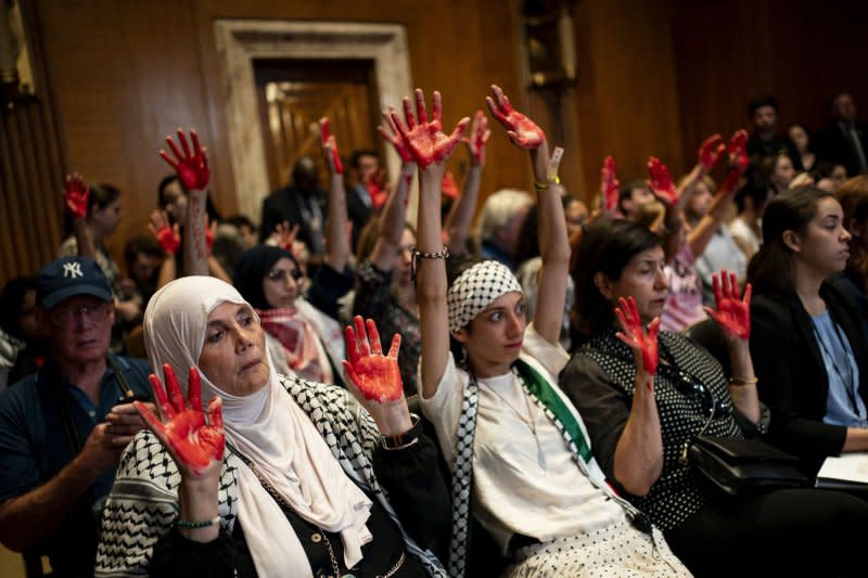 Pro-Palestinian demonstrators hold painted hands as Secretary of State Antony Blinken speaks during a Senate Appropriations Subcommittee on State, Foreign Operations and Related Programs hearing on a proposed $58.8 billion budget request Tuesday. Photo by Bonnie Cash/UPI