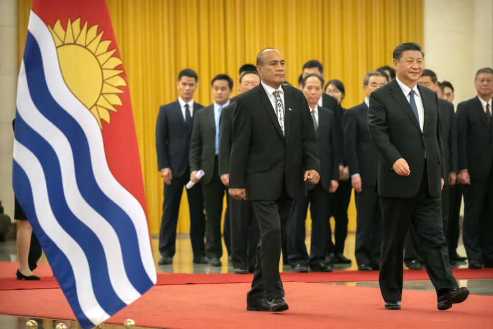 Kiribati's President Taneti Maamau, left, and Chinese President Xi Jinping walk together during a welcome ceremony at the Great Hall of the People in Beijing, Monday, Jan. 6, 2020. (AP Photo/Mark Schiefelbein)