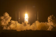 A Long March-5 rocket carrying the Chang'e 5 lunar mission lifts off at the Wenchang Space Launch Center in Wenchang in southern China's Hainan province, early Tuesday, Nov. 24, 2020. China's trip to the moon and, presumably, back is the latest milestone in the Asian powerhouse's slow but steady ascent to the stars. (AP Photo/Mark Schiefelbein, File)