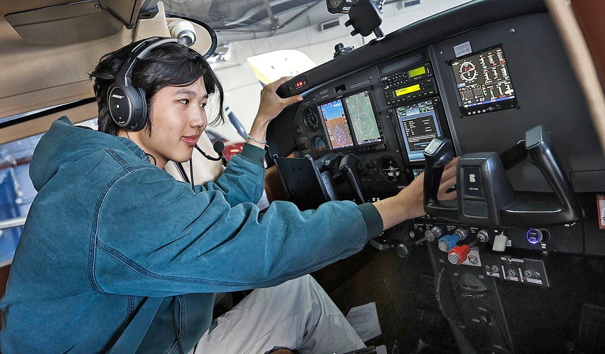 Ethan Guo, 18 of Milton is preparing to fly solo around the world. He has over 600 hours flying planes like his Cessna 182 at Norwood Airport on Friday April 26, 2024