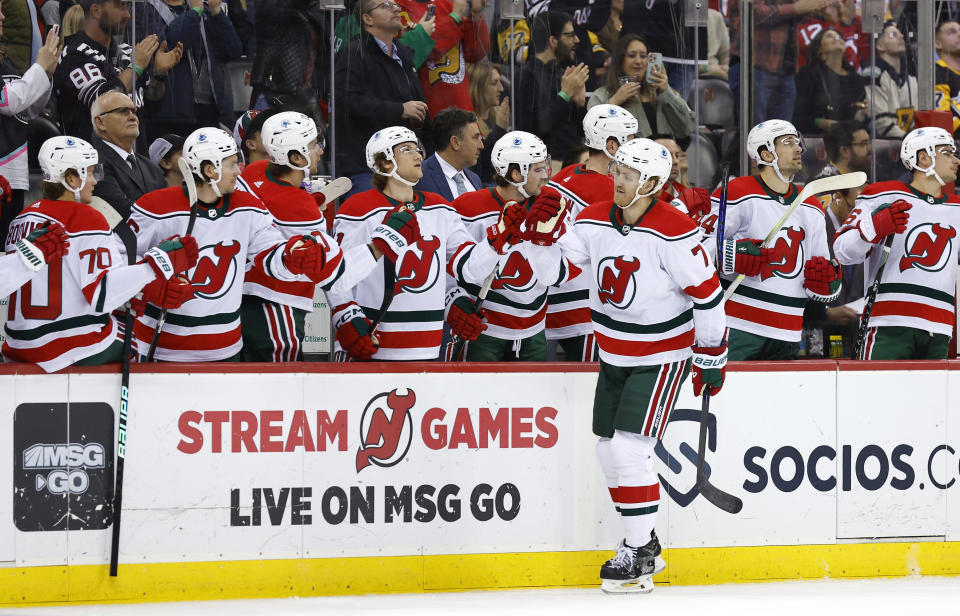 New Jersey Devils defenseman Dougie Hamilton (7) celebrates with teammate after scoring a goal against the Pittsburgh Penguins during the first period of an NHL hockey game Tuesday, April 4, 2023, in Newark, N.J. (AP Photo/Noah K. Murray)