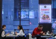 People visit the fast food restaurant Vkusno & tochka in Moscow