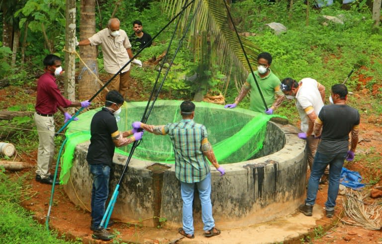 Animal Husbandry department and Forest officials inspect a well to catch bats at Kozhikode earlier this month