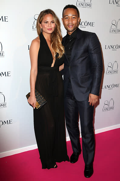 Chrissy Teigen and John Legend wear black & blue at Lancome’s 80th anniversary party.