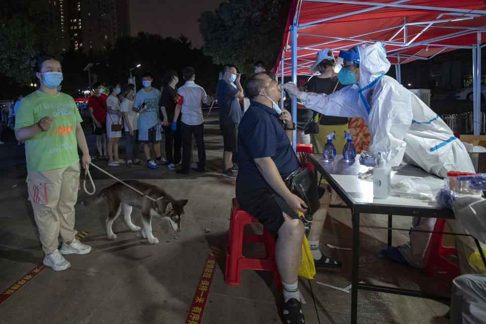 Residents line up for Covid-19 tests in Wuhan in central China's Hubei province Tuesday, Aug. 3, 2021. China's worst coronavirus outbreak since the start of the pandemic a year and a half ago escalated Wednesday with dozens more cases around the country, the sealing-off of one city and the punishment of its local leaders. (Chinatopix Via AP)