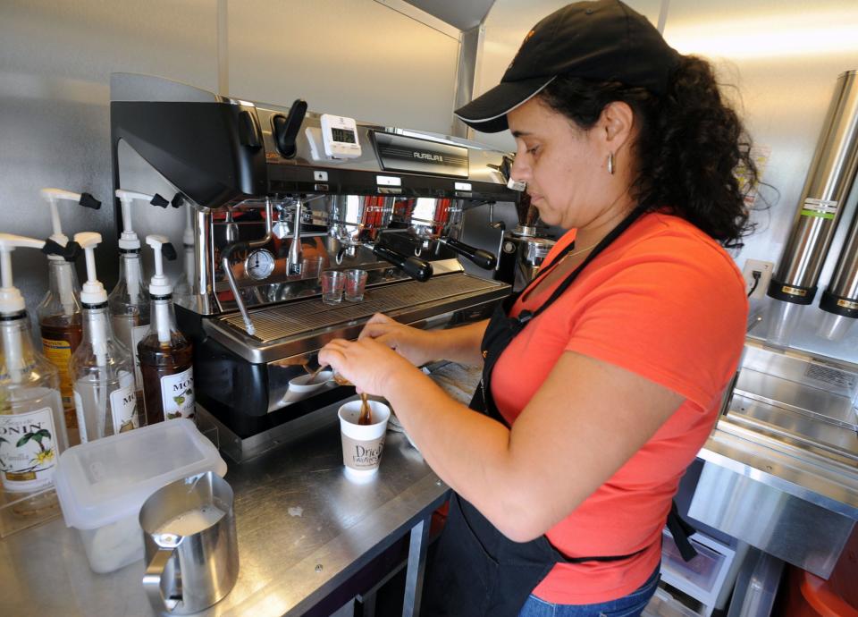 Adriana Mellas pours espresso into a cup while making a latte inside Drica's Favorites Specialty Coffee Boutique, a mobile food truck serving specialty coffees and baked goods, in Lakeland, FL on Monday June 3, 2013.  Scott Wheeler/The Ledger